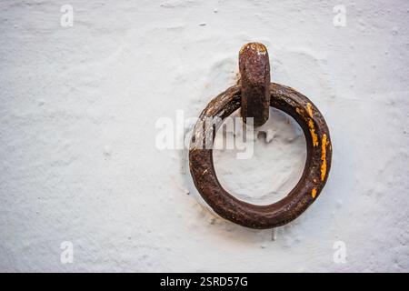 Fixed knocker on the wall to tie a cavalry to it. Malága, Andalucia, Spain, Europe. Stock Photo