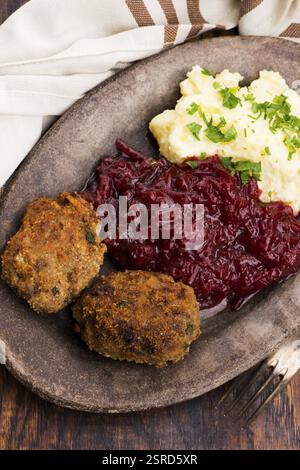 Prepared dinner on the plate. Melted meat, potatoes, beetroot Stock Photo