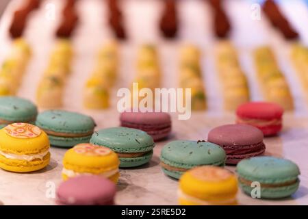 Colorful macarons, various flavors, displayed for a party. Stock Photo