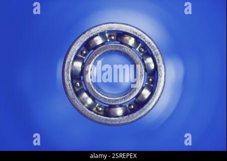 Concept, dot of dot com ball bearing on blue background Stock Photo