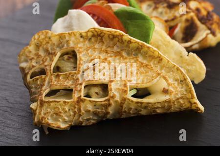 Pancakes sutffed with ham, cheese, tomatoes and spinach Stock Photo