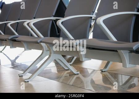 airport seats that are arranged in a row. Stock Photo