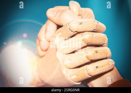 Close up view of robot and human hand arm wrestling Stock Photo