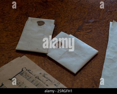 Two letters on old parchment with abrown wax seal and a sheet of notes. Stock Photo
