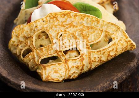 Pancakes sutffed with ham, cheese, tomatoes and spinach Stock Photo