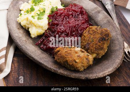 Prepared dinner on the plate. Melted meat, potatoes, beetroot Stock Photo