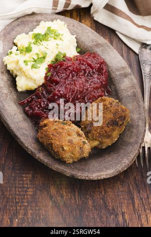Prepared dinner on the plate. Melted meat, potatoes, beetroot Stock Photo