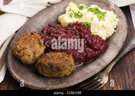 Prepared dinner on the plate. Melted meat, potatoes, beetroot Stock Photo