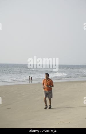 South Asian Indian young man doing morning activity running on seashore MR#703D Stock Photo