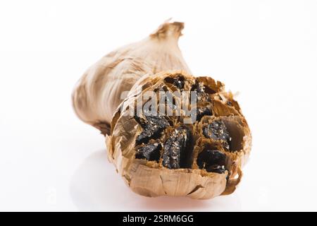 Black garlic cloves isolated on white background Stock Photo