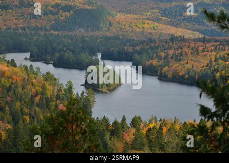 Wapizagonke lake at La Mauricie Canada Park at fall.  Island and lake on an autumn day. Fall season colors with lake forest and mountains. Stock Photo