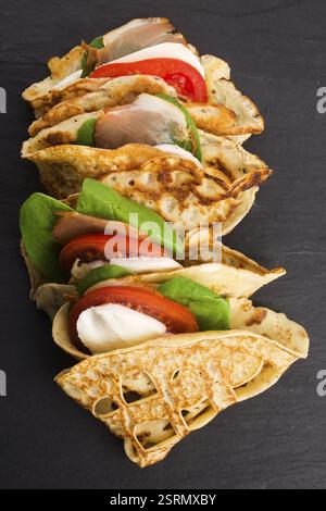 Pancakes sutffed with ham, cheese, tomatoes and spinach Stock Photo