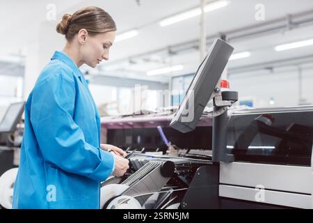 Worker confectioning electronic parts on assembly line Stock Photo