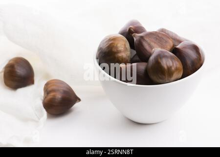 Bowl of chestnuts on a white background Stock Photo