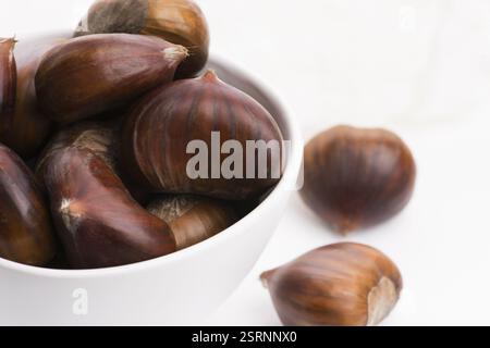 Bowl of chestnuts on a white background Stock Photo