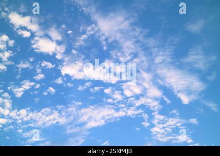 Beautiful White Altocumulus Clouds Scattered on Bright Blue Sky Stock Photo