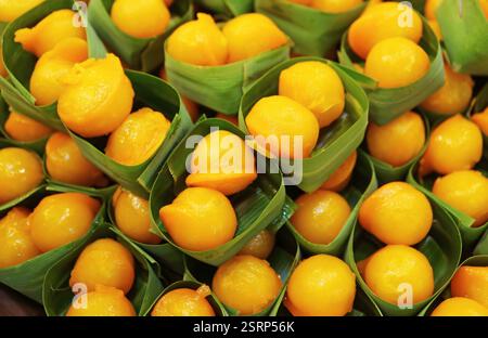 Rows of Med Kanoon,  Thai Traditional Dessert Made of Sweetened Beans Paste Dipped in Beaten Egg Yolks and Cooked in Syrup Stock Photo