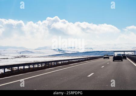 M1 North-South highway at plain of Shirak Province of Armenia on sunny winter day (view through car windshield) Stock Photo