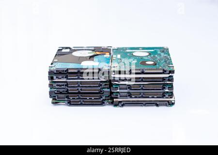 Stacks of hard disk drives on a white background.  Data storage, technology, and recycling concepts. Stock Photo