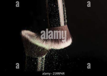 Cosmetics brush and colorful makeup powder Stock Photo