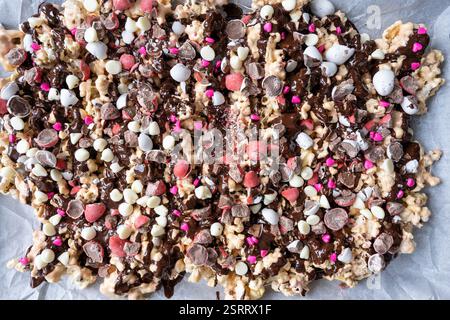 An irresistible mix of popcorn coated in melted dark chocolate, gooey marshmallows, and crunchy, colorful candies Stock Photo