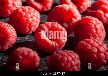 raspberry on black wood background Stock Photo