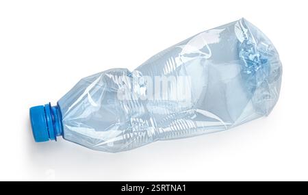 Empty crushed plastic bottle with blue cap lying on a white background representing recycling and environmental conservation Stock Photo
