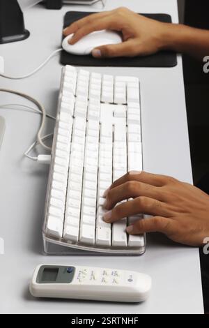 Remote control of air conditioner kept on computer table, India, Asia Stock Photo