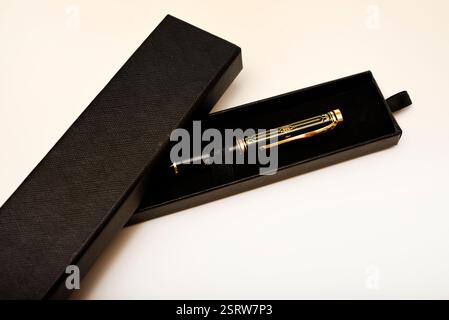 A gift pen in a box. A black fountain pen. Stock Photo