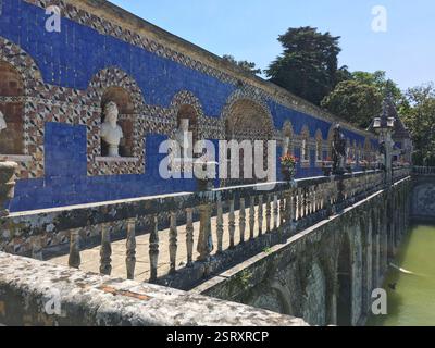 Palacio dos Marqueses de Fronteira. Beautiful blue and white tiled wall with intricate patterns and sculptures. A walkway with stone railings overlook Stock Photo