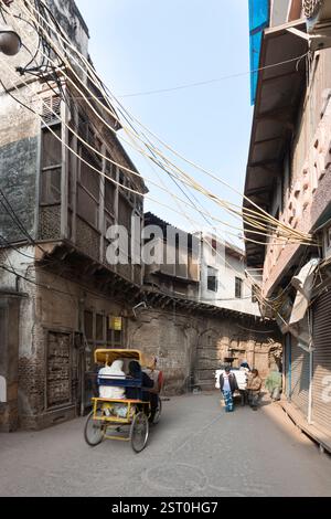 Cycle rickshaw on a sidestreet in Delhi, India Stock Photo