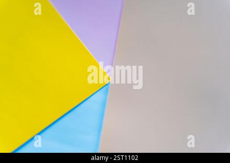 Creative abstract background made of overlapping yellow, blue, purple, and neutral-colored paper. Modern geometric composition suitable for design, br Stock Photo
