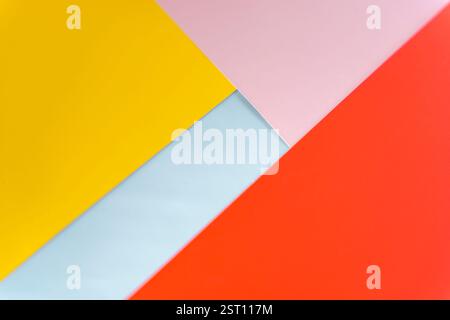 Modern abstract background featuring overlapping yellow, red, pink, and blue paper layers. Vibrant geometric composition ideal for design, branding, o Stock Photo