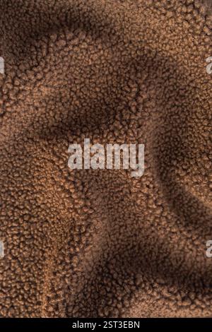 High-resolution macro shot of curly teddy recycled polyester fleece fabric. Stock Photo