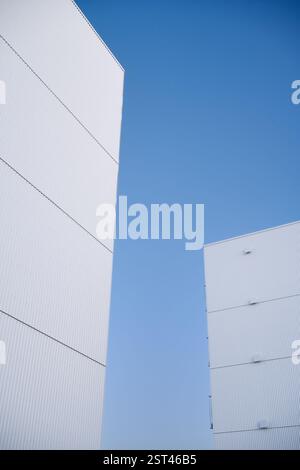 Modern white corrugated iron buildings reaching for the blue sky Stock Photo
