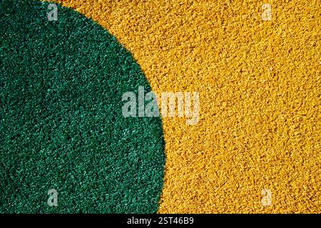 Vibrant green circle on textured yellow surface Stock Photo