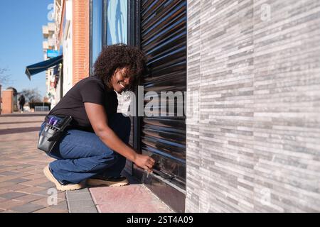 Happy hairdresser opening her shop in the morning Stock Photo