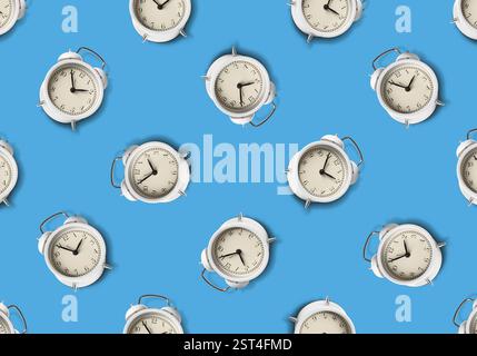 Pattern of white alarm clocks on pale blue background Stock Photo
