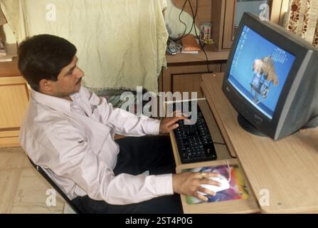 Man working on computer at home, bombay mumbai, maharashtra, india MR Stock Photo