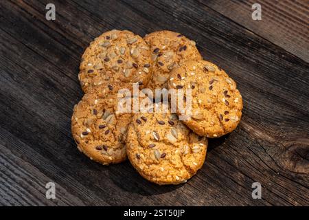 Heart shaped cookies on wooden table, sweet homemade Heart-shaped cookies with oat flakes. Oatmeal cookies with sesame seeds. oatmeal cookies with see Stock Photo