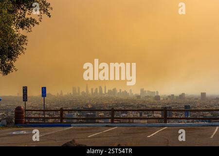 Los Angeles, California - January 8, 2025: Dramatic view of the Los Angeles skyline shrouded in smoke during a wildfire, casting an orange hue over th Stock Photo