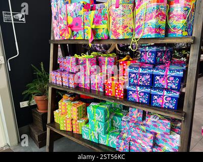 Lviv, Ukraine - February 16, 2025: Brightly colored gift boxes with ribbon decorations displayed on a wooden shelf. Stock Photo