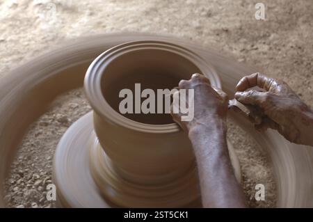 Pottery, The traditional Indian kumbhar (potter) Earthen Clay pot maker, Making Clay pot on the Wheel, Rural workmanship of earnings, Malewad, Shiroda Stock Photo