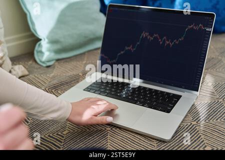 Laptop screen with market analysis charts, woman working on computer Stock Photo