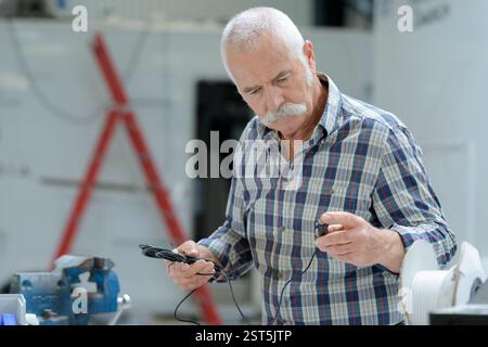 a senior technician using screwdriver Stock Photo