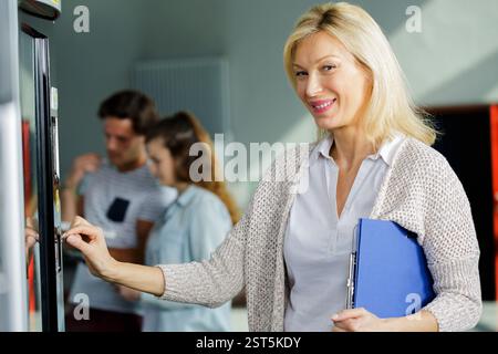 woman pushing button on vending machine Stock Photo