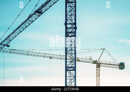 Two construction cranes on site, selective focus Stock Photo