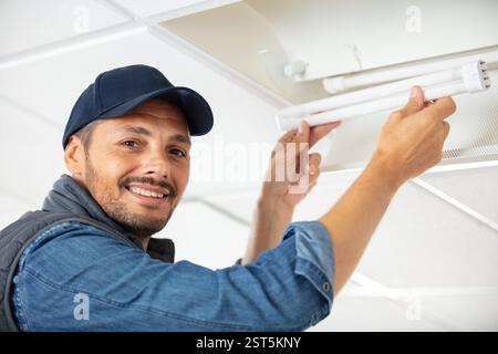 the electrician is setting a light bulb for temporary lighting Stock Photo