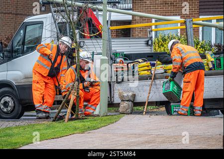 workmen repairing a lamppost in the street following an accident. Stock Photo