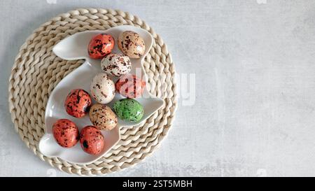 Chocolate caramelised eggs - a sweet treat for Easter. Easter background top view of a bunny-shaped dish with chocolate candies in the form of eggs on Stock Photo